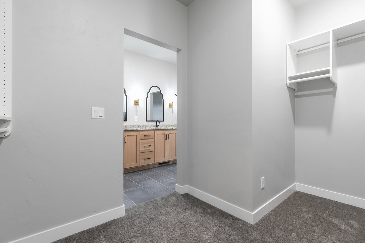 Closet with view into master bath in Fremont WI custom home by Midwest Design Homes