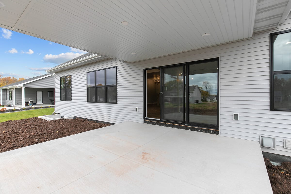 Covered back patio with sliding glass doors by Midwest Design Homes in Kaukauna, WI