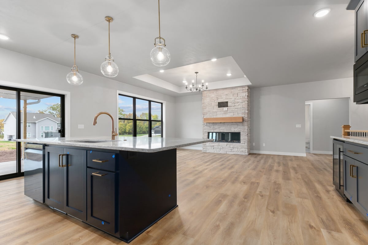 Custom home kitchen island and fireplace design in Kaukauna by Midwest Design Homes