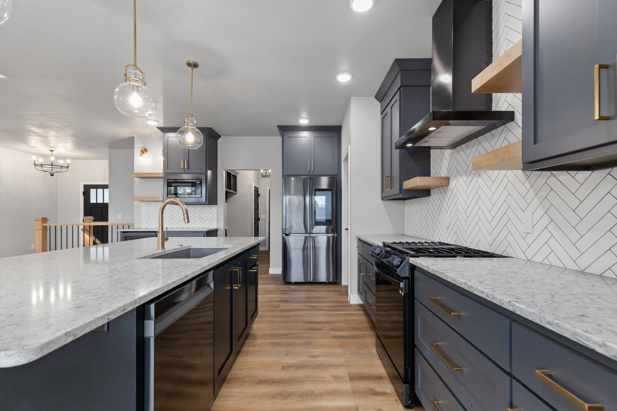 Custom kitchen island and lighting in Kaukauna home by Midwest Design Homes