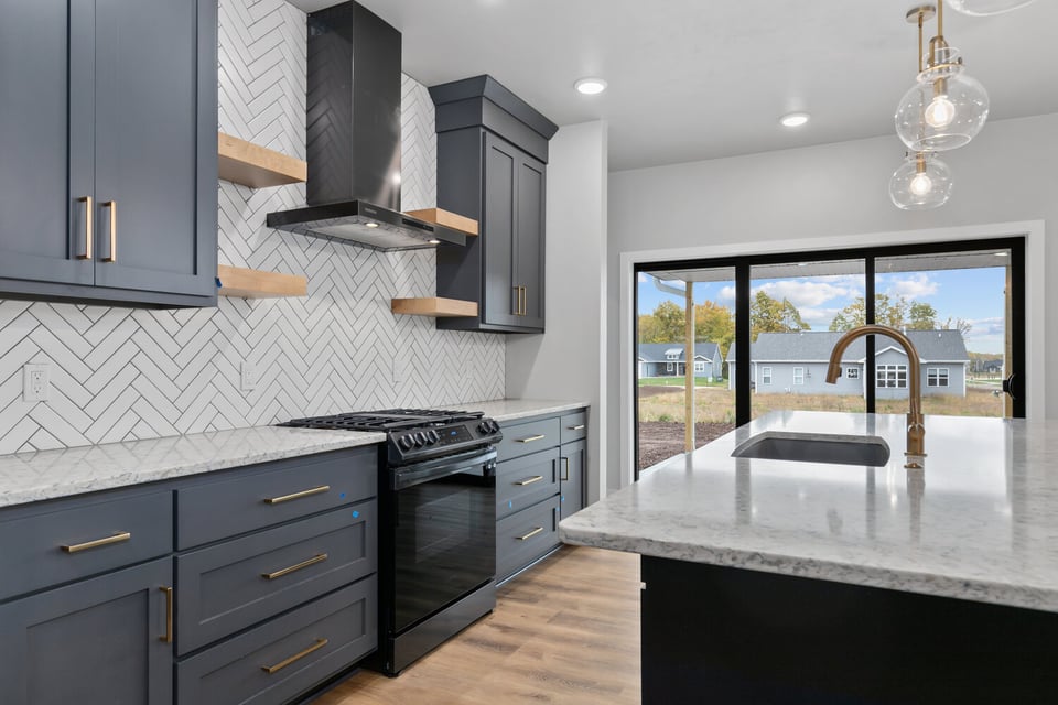Custom kitchen with herringbone tile backsplash by Midwest Design Homes in Kaukauna, WI