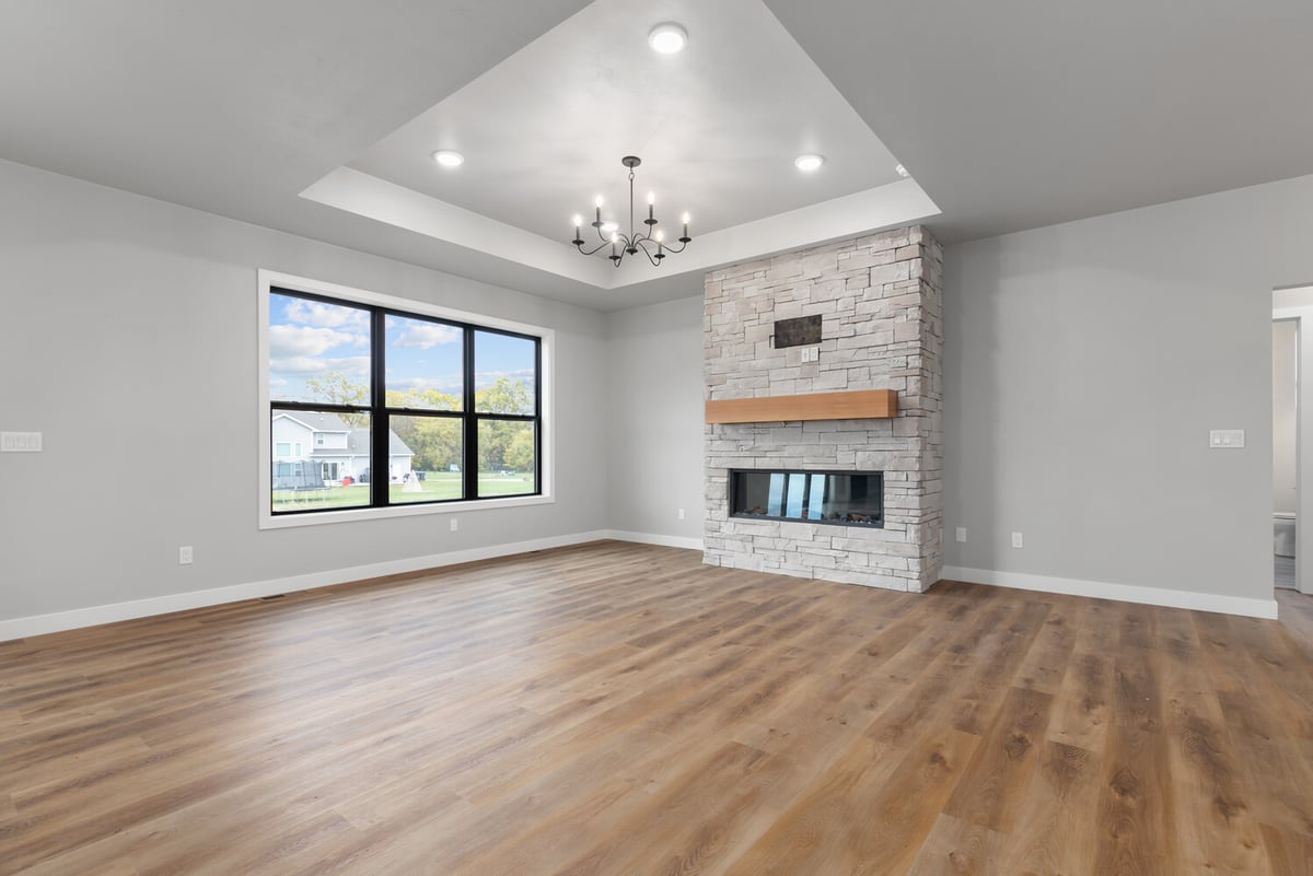 Fireplace focal point and natural light in Kaukauna custom home by Midwest Design Homes