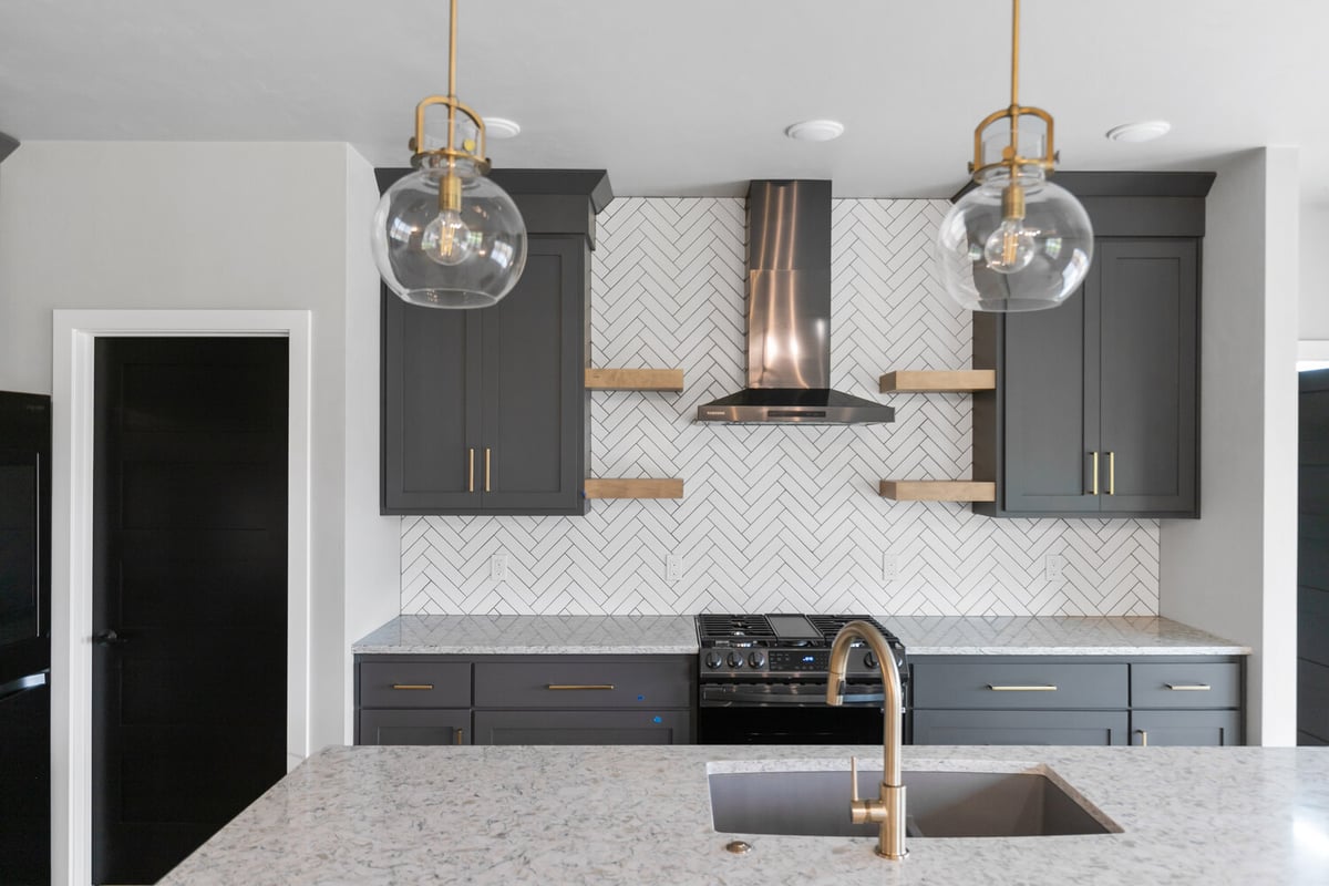 Kitchen design with gray cabinets and open shelves by Midwest Design Homes in Wisconsin