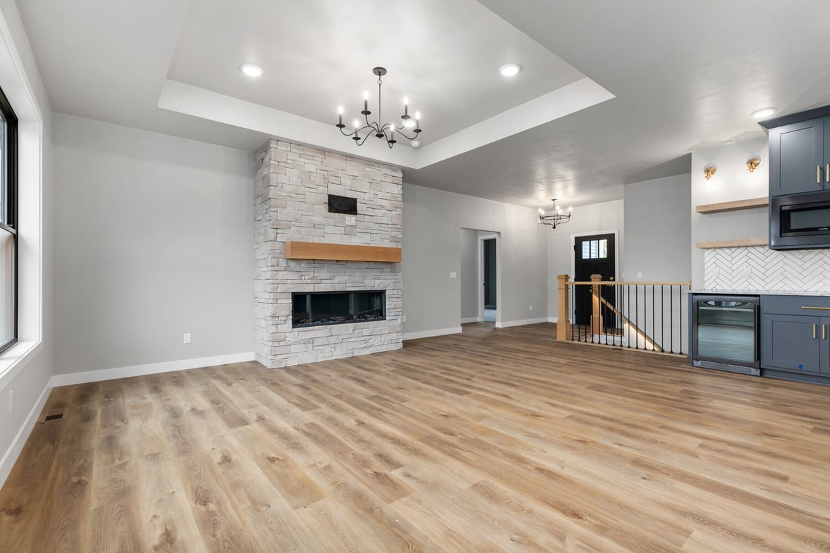 Living room fireplace and stair access in Kaukauna custom build by Midwest Design Homes