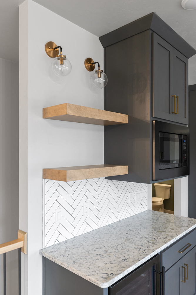 Modern floating shelves and tile backsplash in Kaukauna custom kitchen remodel by Midwest