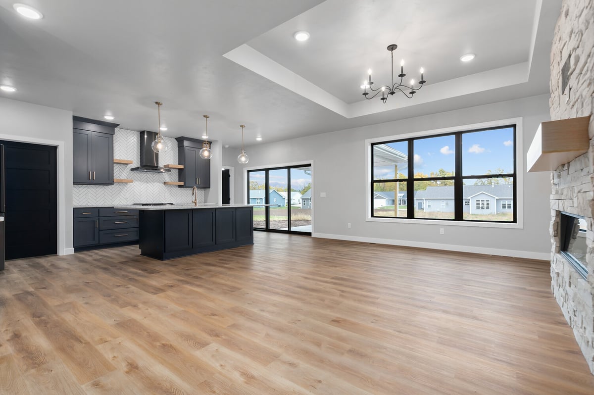 Open kitchen and living space in Kaukauna custom home by Midwest Design Homes