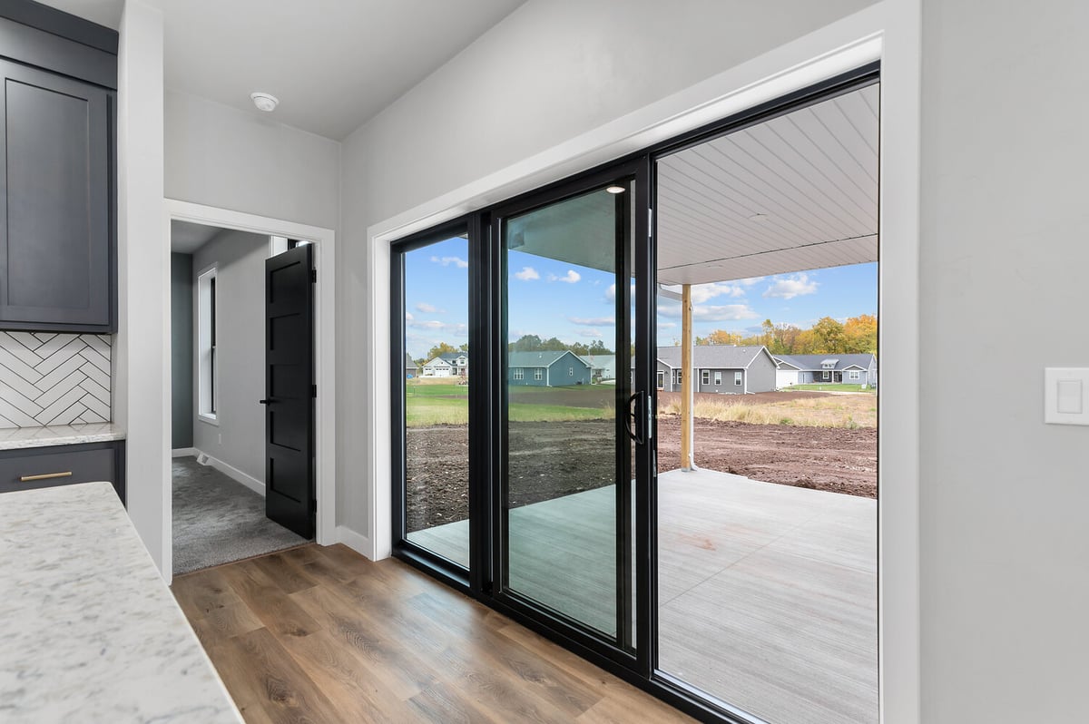 Sliding doors leading to covered patio in custom Kaukauna home by Midwest Design Homes