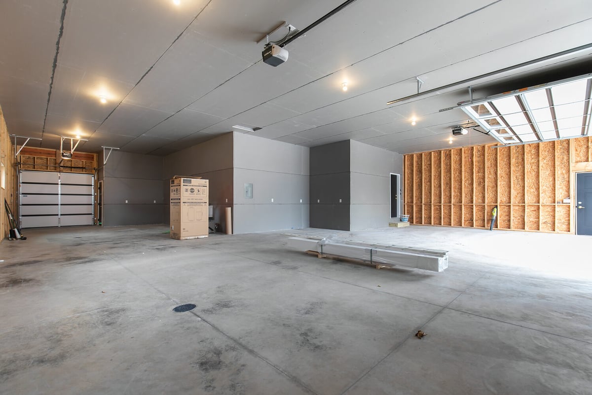 Spacious 3-car garage interior in custom home by Midwest Design Homes in Fox Cities WI