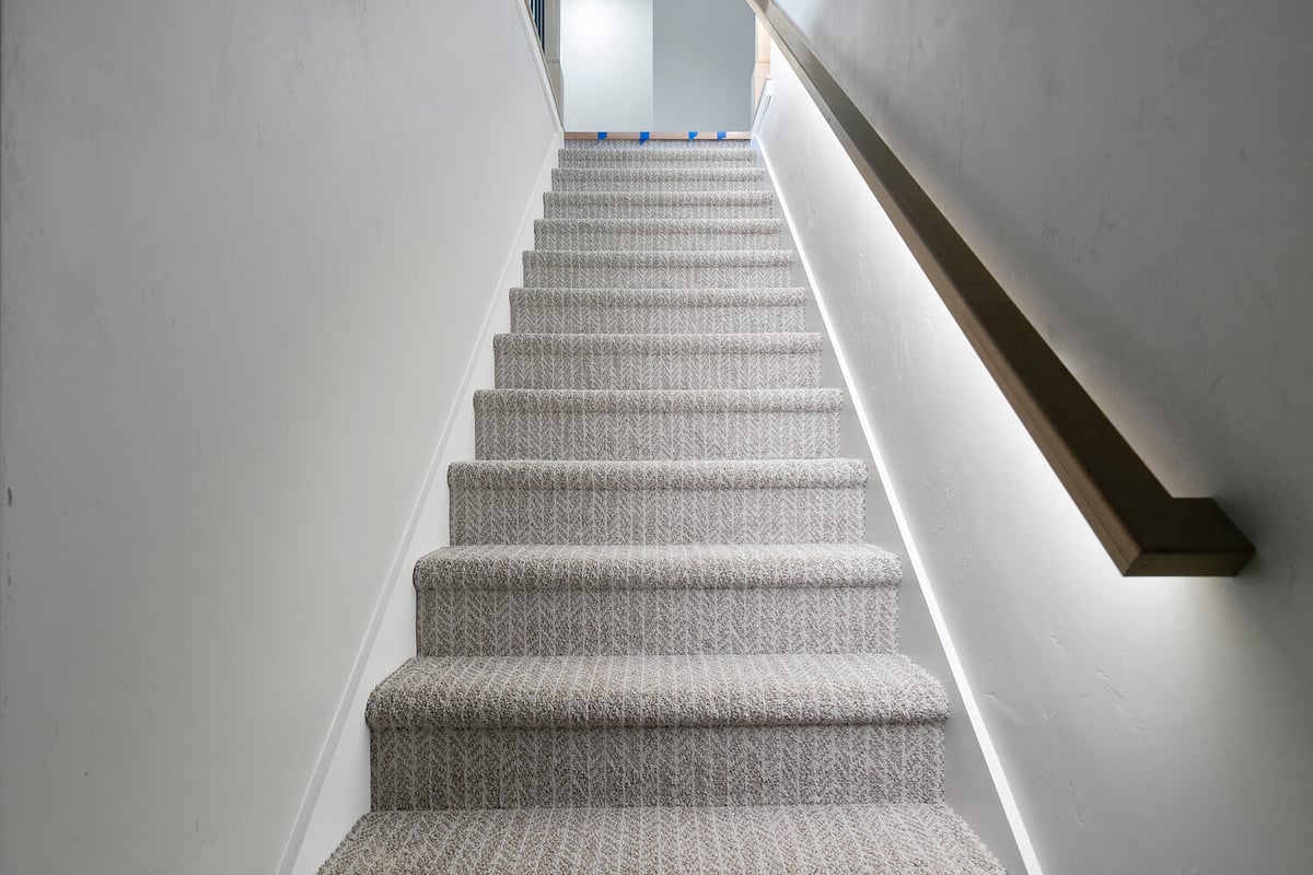 Staircase with modern handrail design by Midwest Design Homes in Greenville Wisconsin