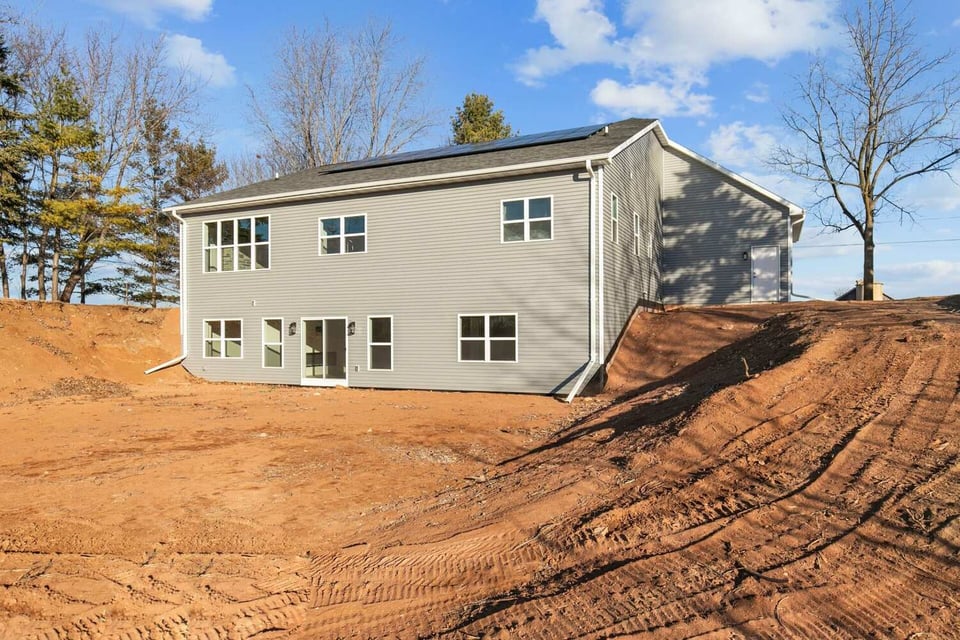 Back exterior of gray custom home under construction by Midwest Design Homes in Kaukauna, WI