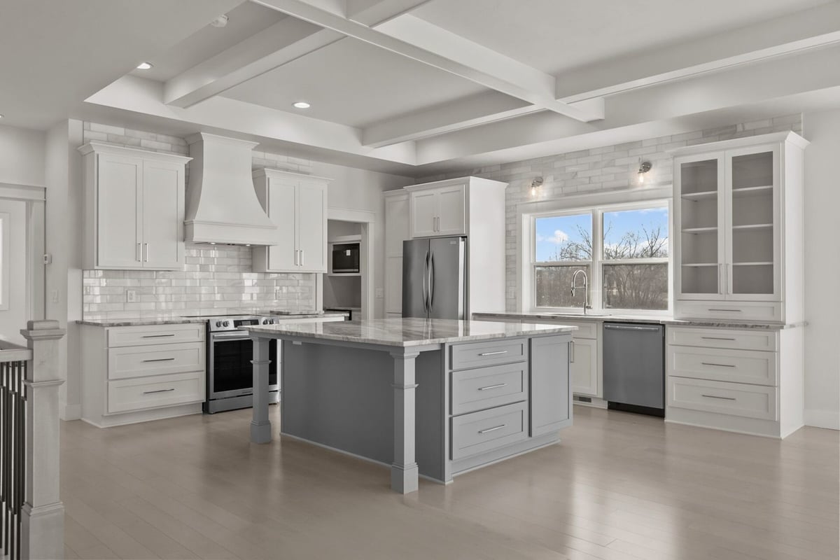 Bright custom kitchen with white cabinetry and island by Midwest Design Homes in Kaukauna, WI
