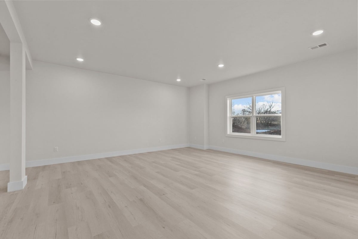 Bright open-concept living space with wood flooring by Midwest Design Homes in Kaukauna, WI