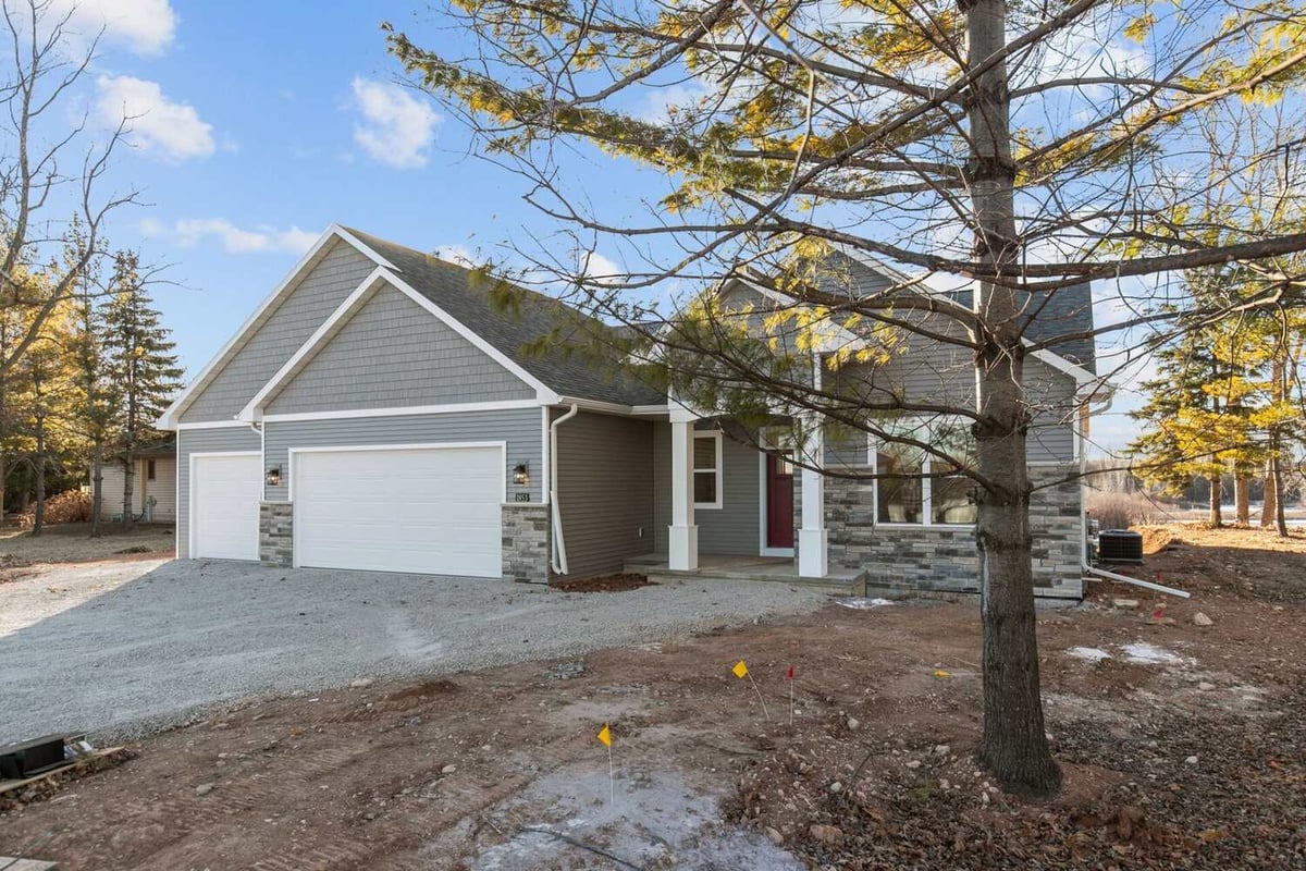 Custom home exterior with three-car garage by Midwest Design Homes in Kaukauna, Wisconsin
