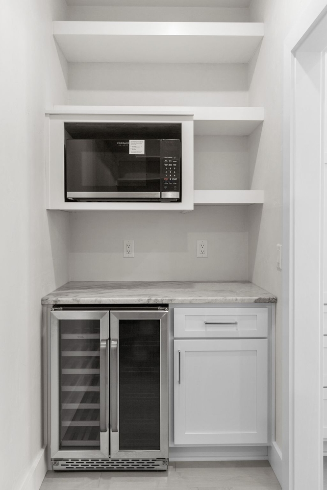 Custom pantry with wine cooler and microwave by Midwest Design Homes in Kaukauna, Wisconsin