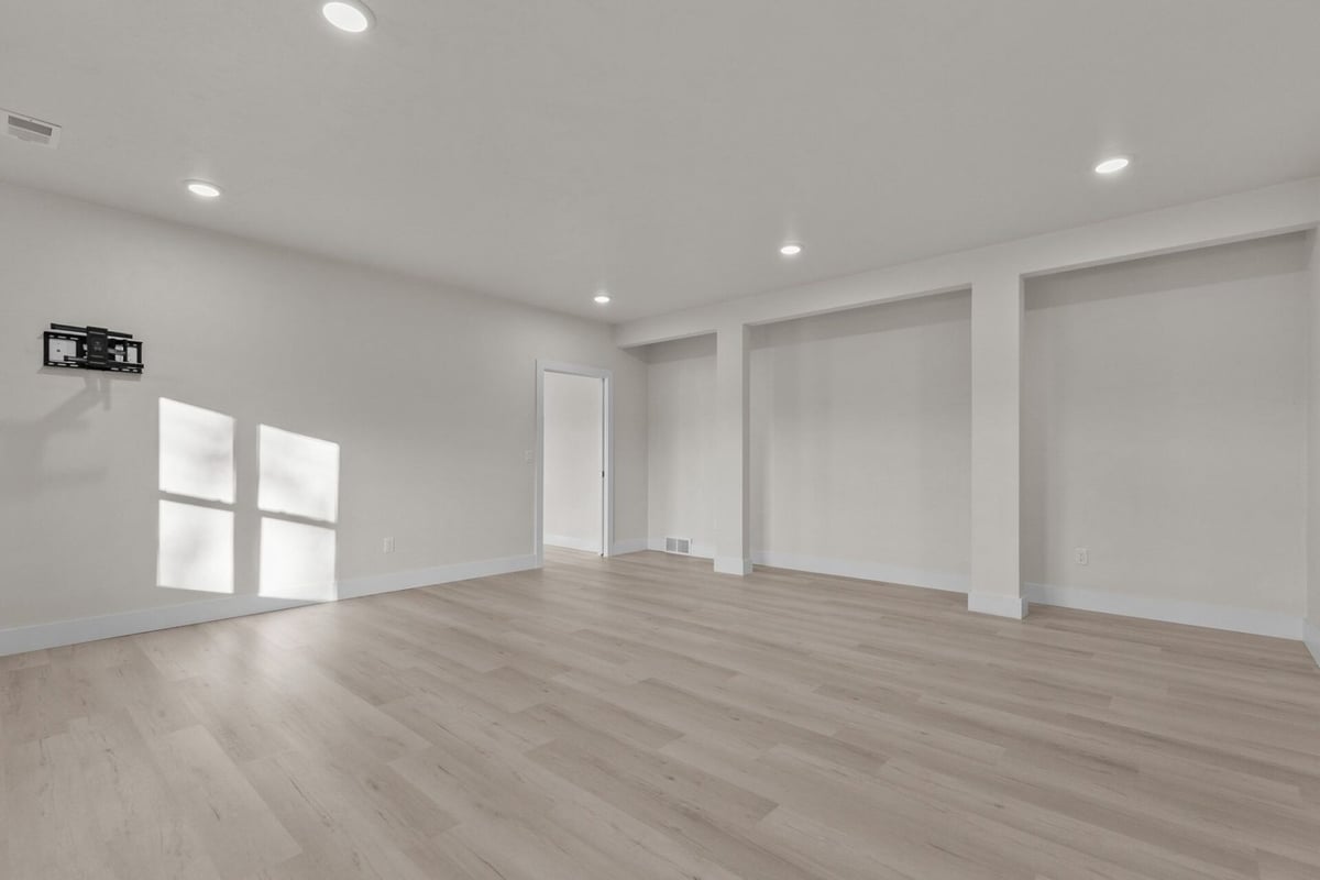 Finished lower-level rec room with TV mount by Midwest Design Homes in Kaukauna, WI