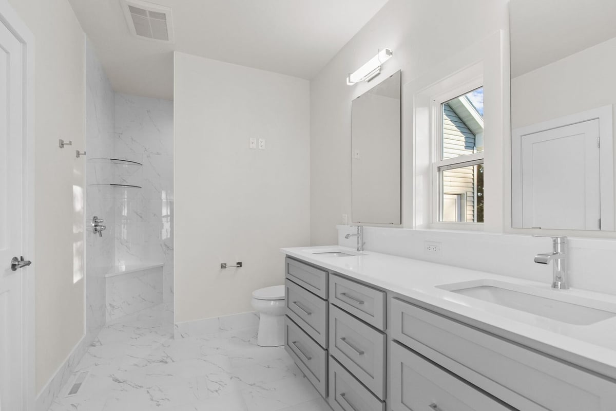 Full view of custom bathroom with marble flooring by Midwest Design Homes, Wisconsin