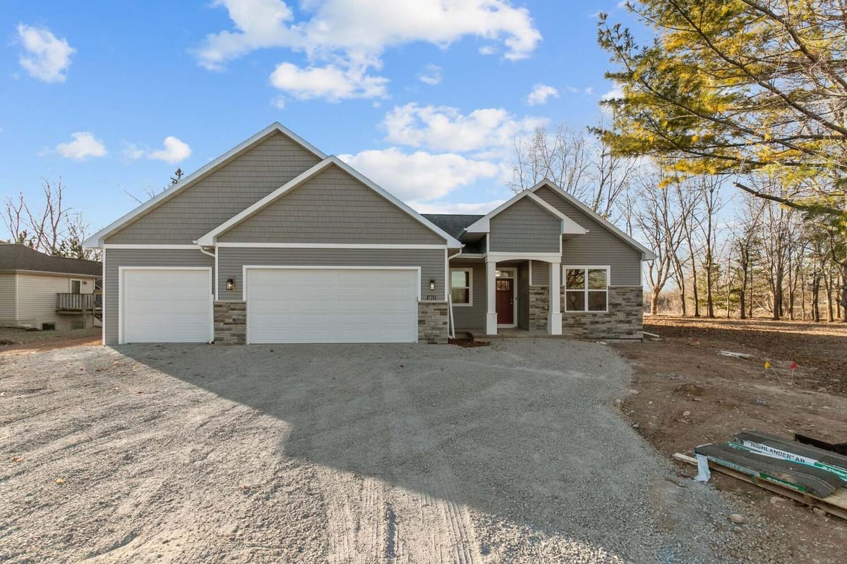 Gravel driveway and finished exterior of custom home by Midwest Design Homes in Kaukauna, WI