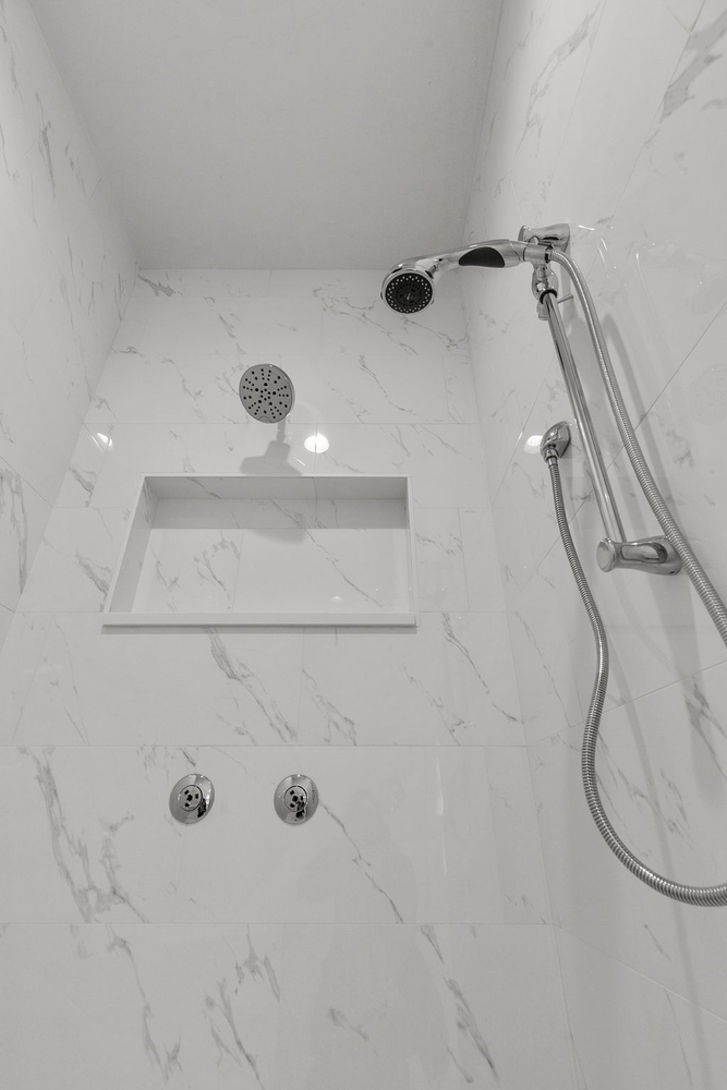 High-end walk-in shower with rain head in Kaukauna custom home by Midwest Design Homes