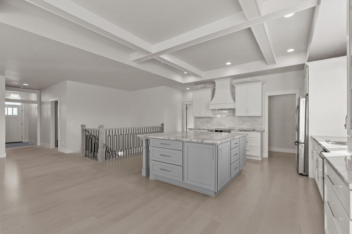 Spacious kitchen with coffered ceiling and large island by Midwest Design Homes in Kaukauna, WI