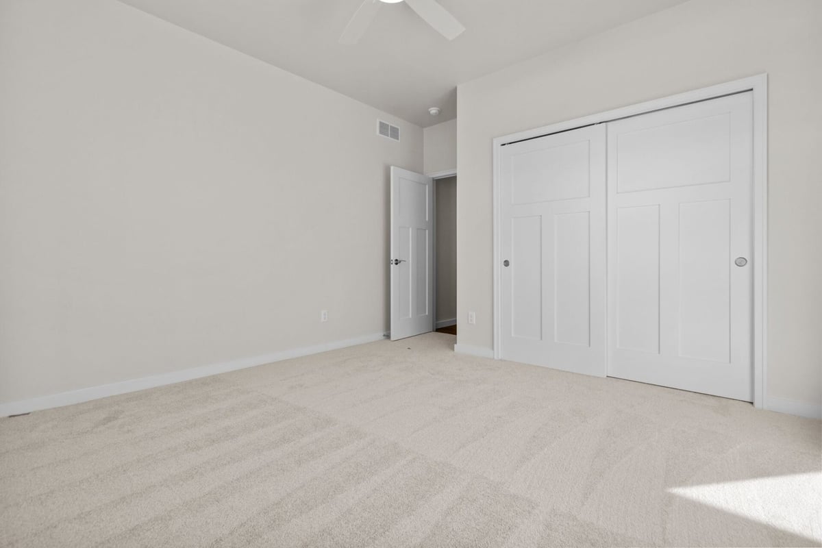 Bedroom with double closet doors by Midwest Design Homes in Appleton, Wisconsin
