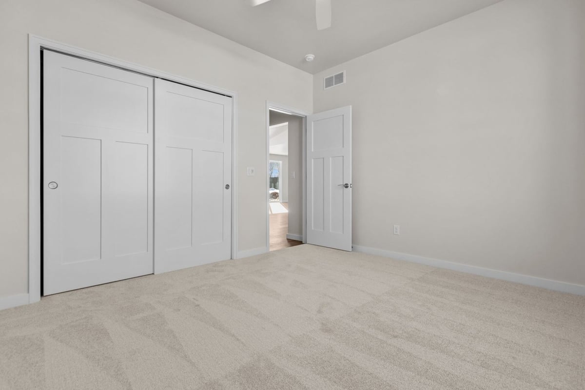 Bedroom with sliding closet doors by Midwest Design Homes in Fox Cities, Wisconsin