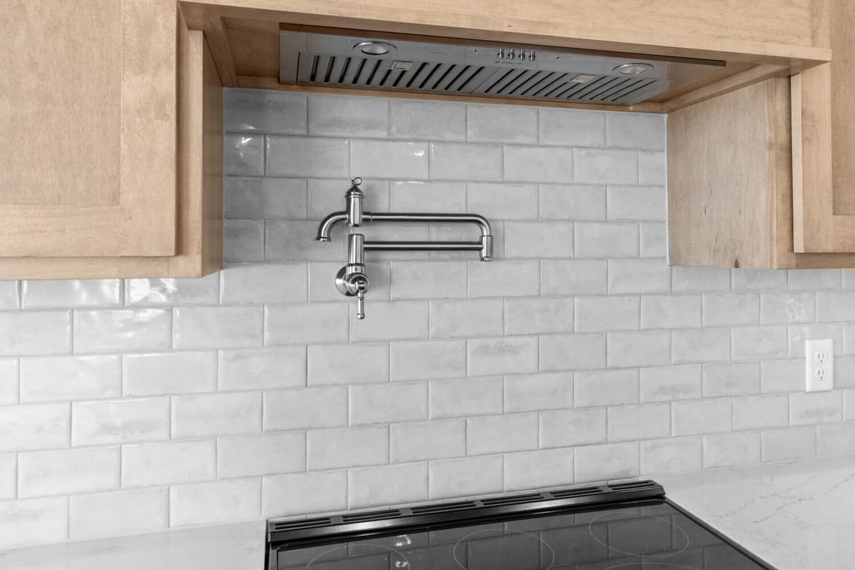 Custom kitchen faucet with tile backsplash by Midwest Design Homes in Kaukauna, WI