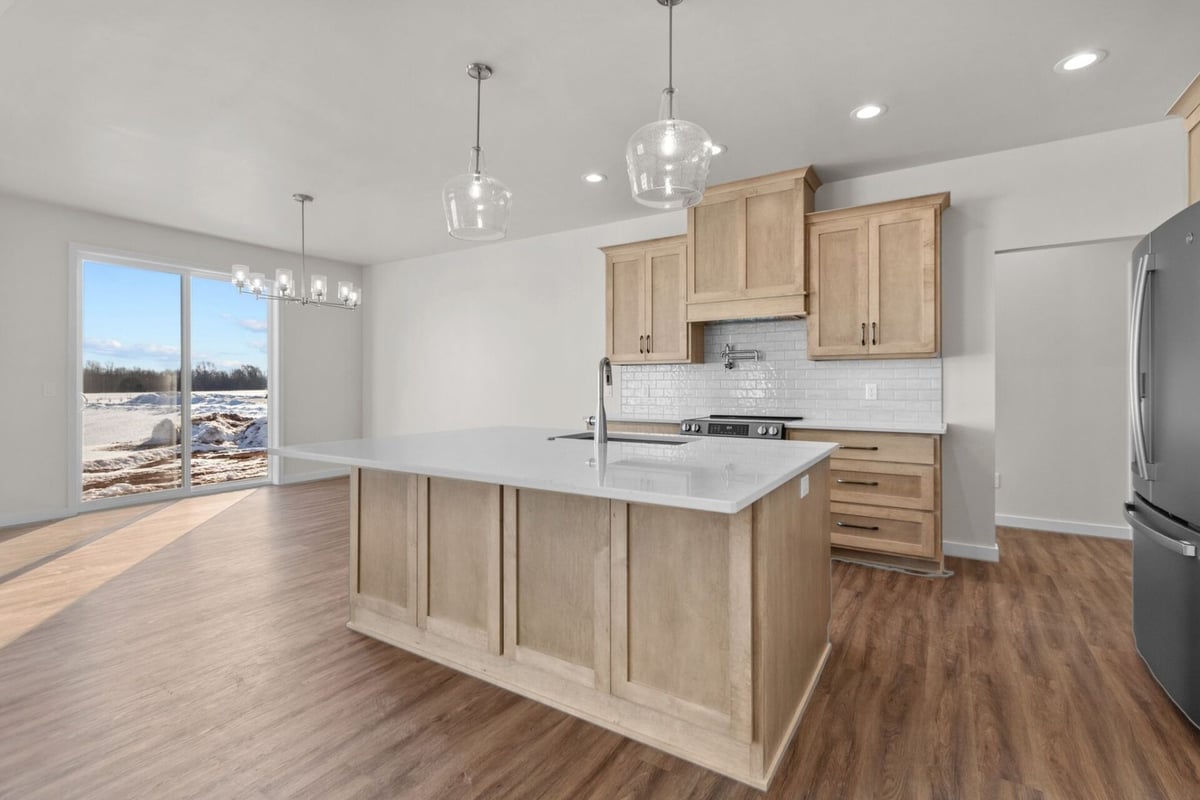 Custom kitchen with pendant lighting by Midwest Design Homes in Green Bay, Wisconsin