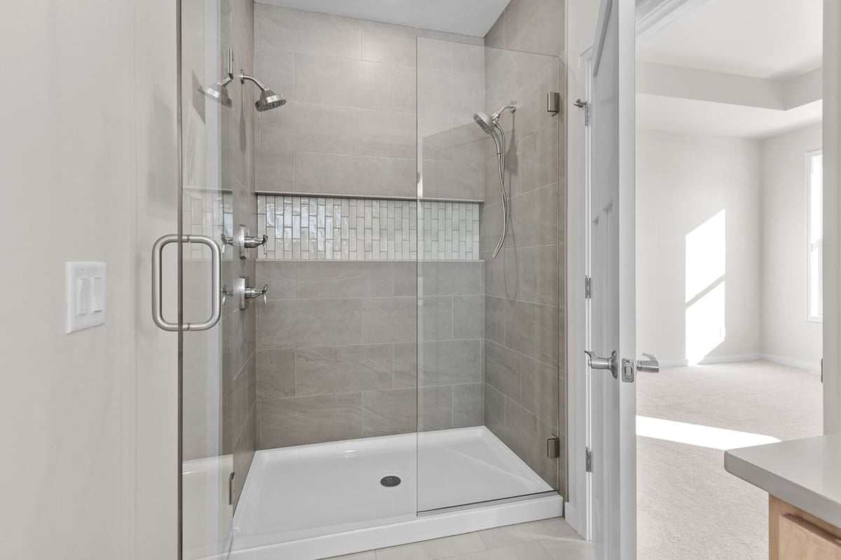 Dual showerheads and tiled shower by Midwest Design Homes in Harrison, Wisconsin