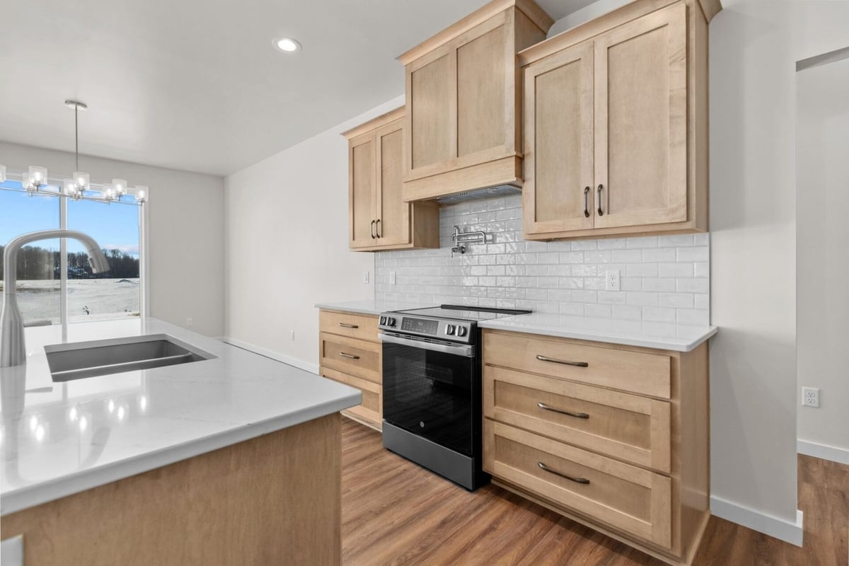 Electric range with pot filler in kitchen by Midwest Design Homes in Neenah, Wisconsin
