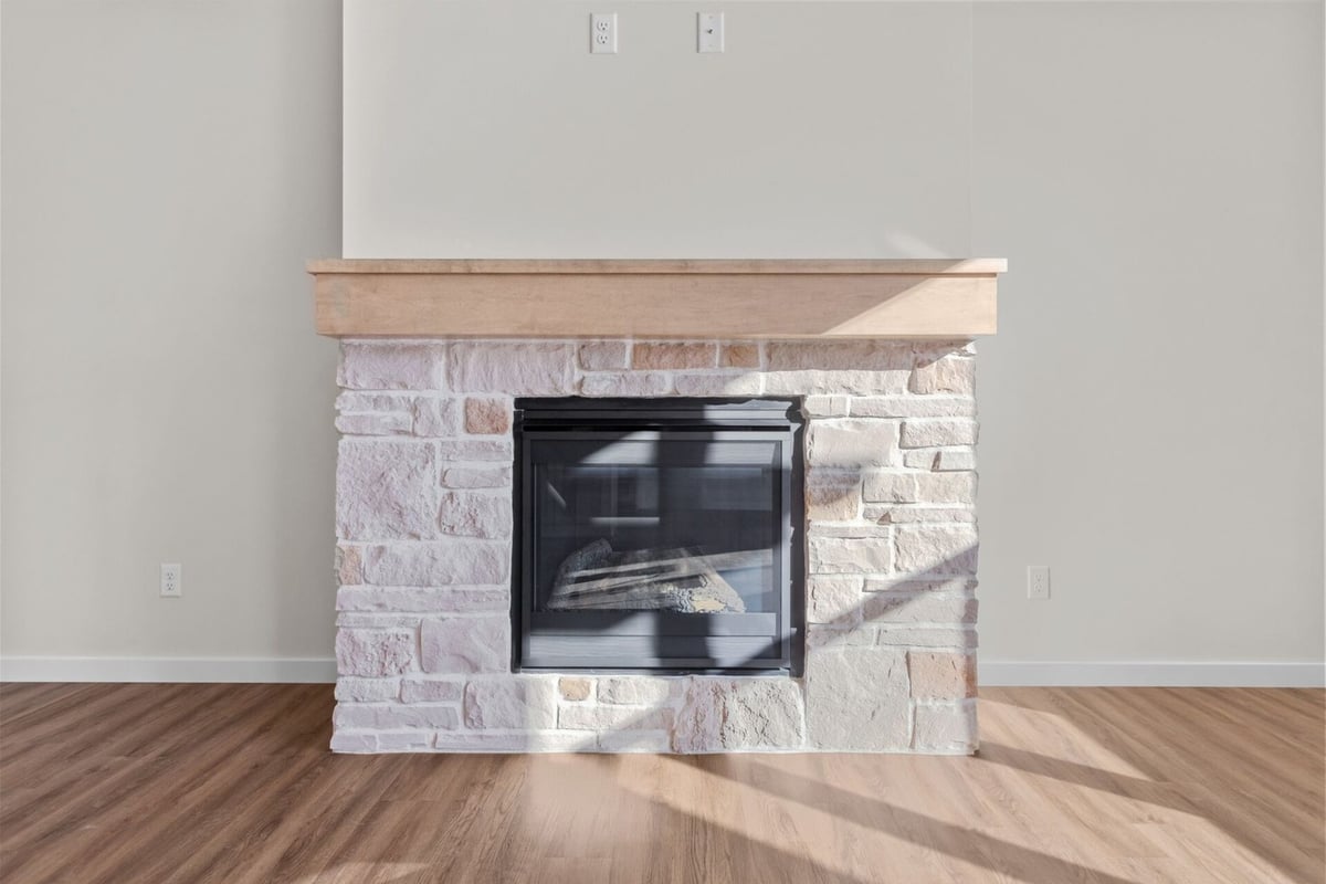 Feature fireplace with rustic stone in new home by Midwest Design Homes, Neenah, WI