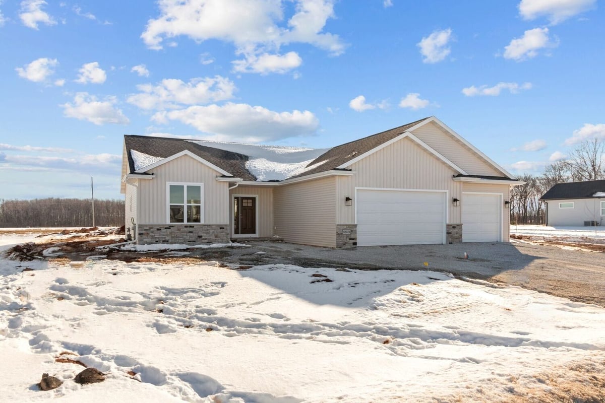 Front exterior of three-car garage custom home by Midwest Design Homes, Kaukauna, WI