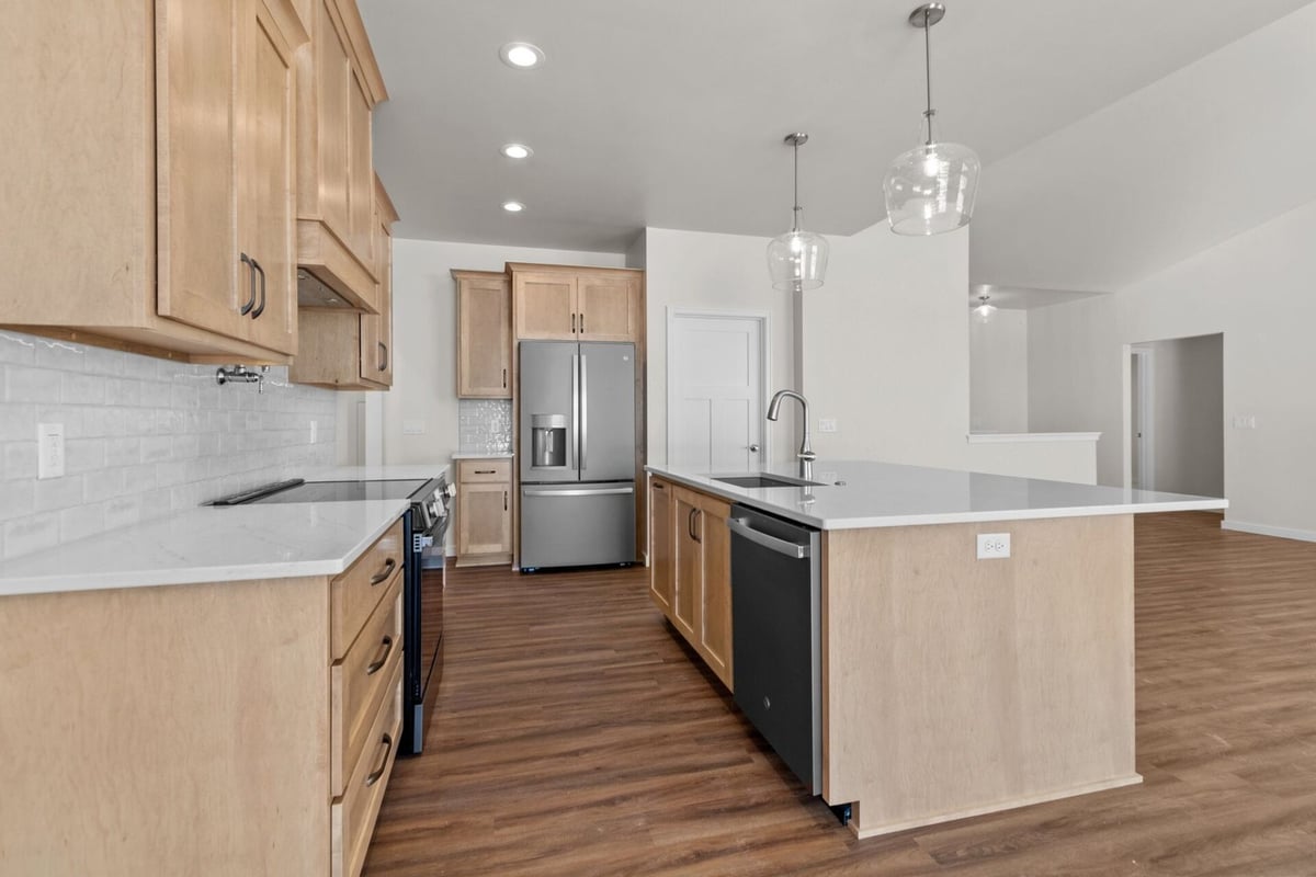 Island kitchen with stainless appliances by Midwest Design Homes in Lawrence, WI