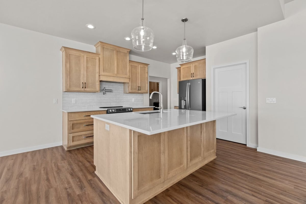 Kitchen island with quartz surface by Midwest Design Homes in Appleton, Wisconsin