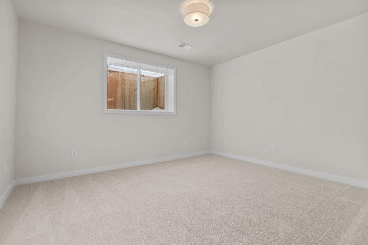 Lower level bedroom with egress window by Midwest Design Homes in De Pere, Wisconsin