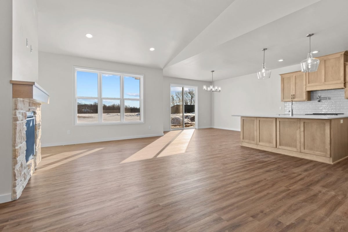 Open floor plan with kitchen and fireplace by Midwest Design Homes in Harrison, Wisconsin