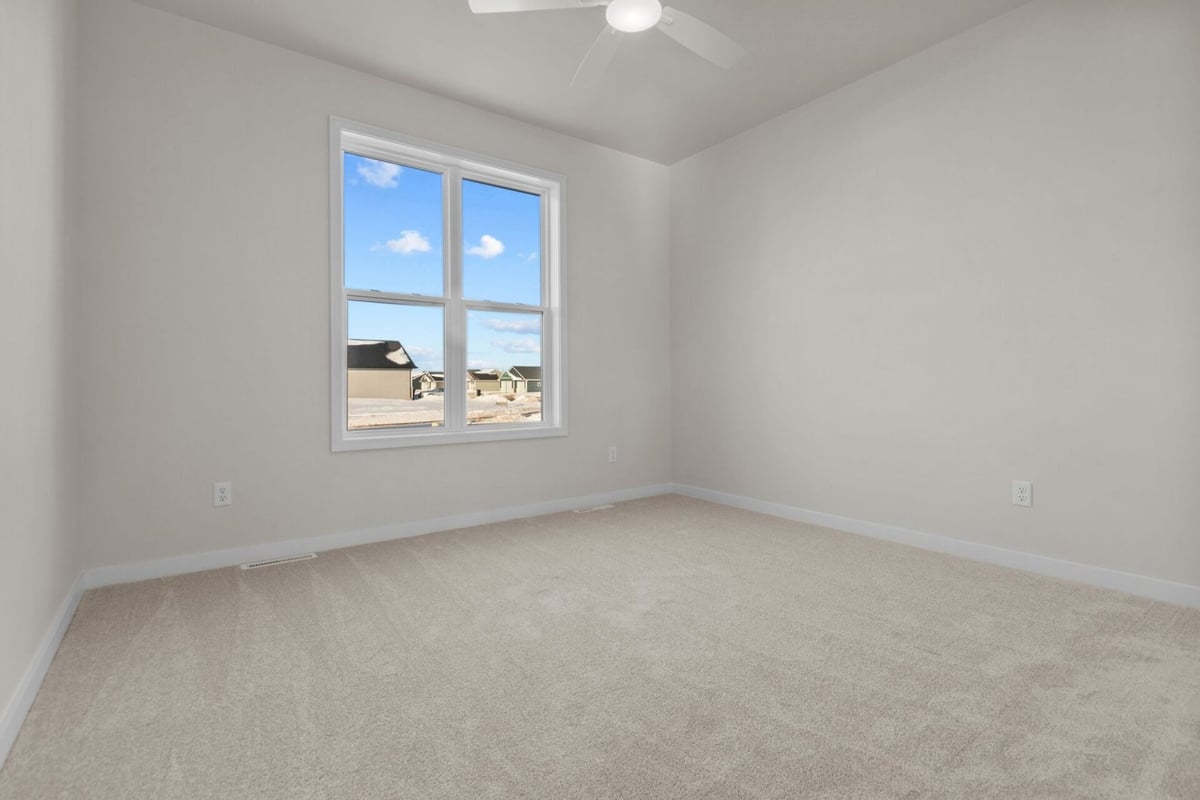 Sunlit carpeted room in Appleton custom home by Midwest Design Homes, Wisconsin