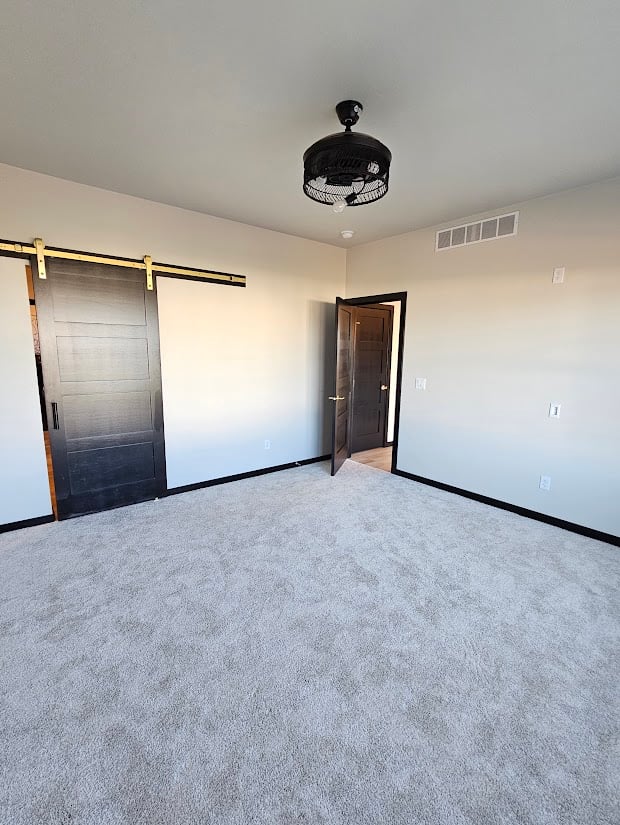 Bedroom with barn door and black trim by Midwest Design Homes, Kaukauna, Wisconsin