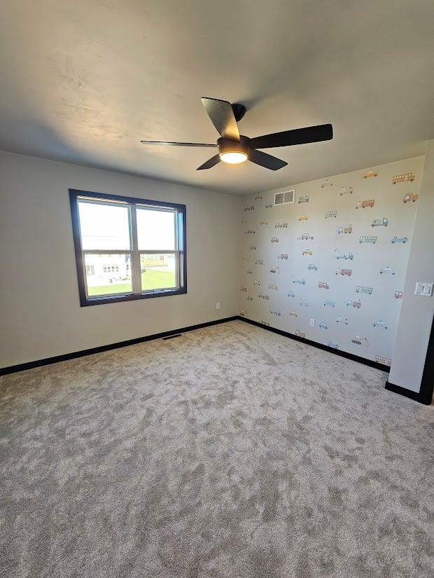 Bright kids room with vehicle-themed wall and fan by Midwest Design Homes, Wisconsin