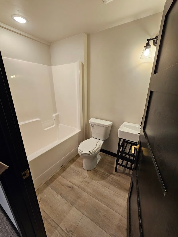 Guest bathroom with walk-in tub and compact vanity by Midwest Design Homes in WI