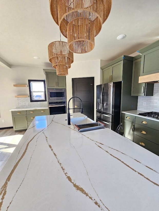 Kitchen island with waterfall quartz countertop in custom home by Midwest Design Homes