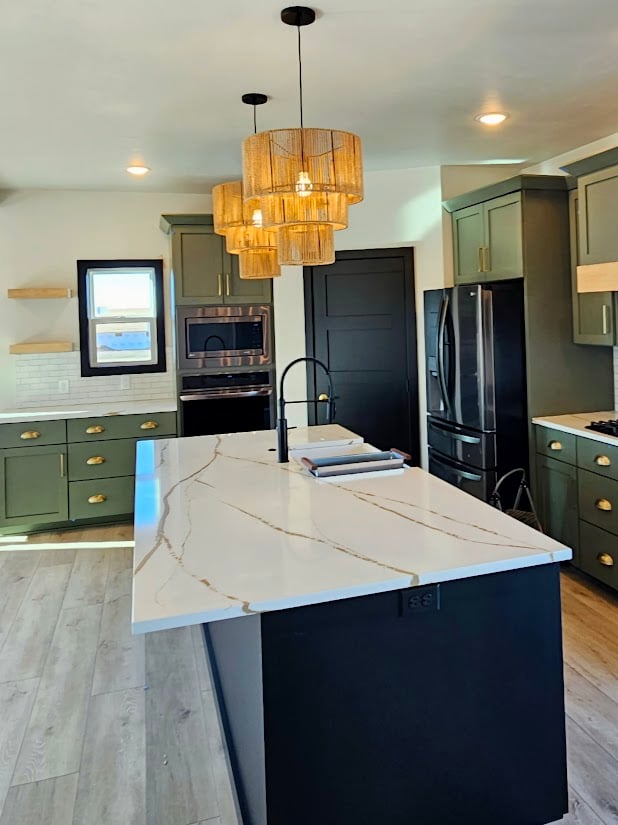 Kitchen with green cabinets and quartz island by Midwest Design Homes in Wisconsin