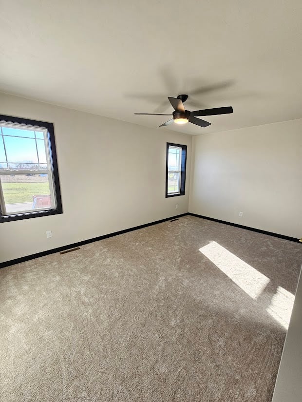 Spacious custom bedroom with windows and fan by Midwest Design Homes, Kaukauna, WI