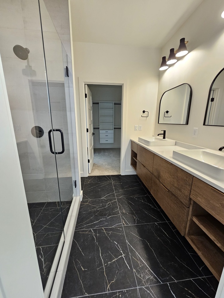 Custom bathroom with vessel sinks and walk-in shower by Midwest Design Homes in Kaukauna