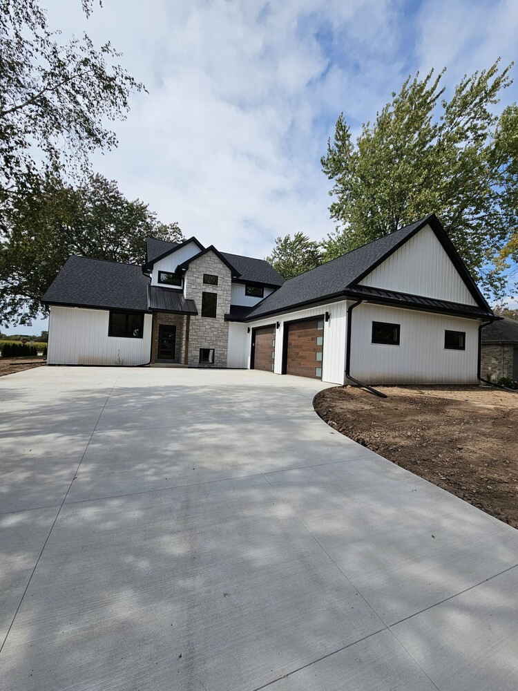 Driveway leading to new custom home with three-car garage in Kaukauna by Midwest Design Homes