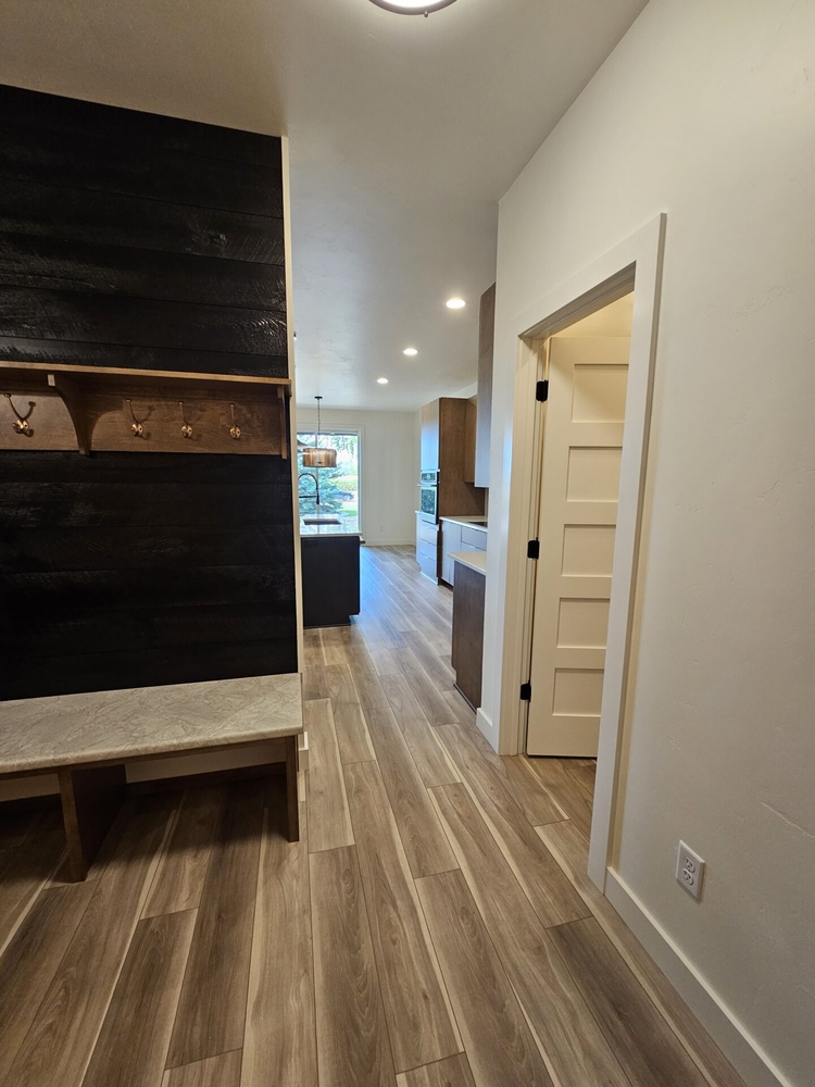 Entry hallway with view into open kitchen space by Midwest Design Homes in Kaukauna