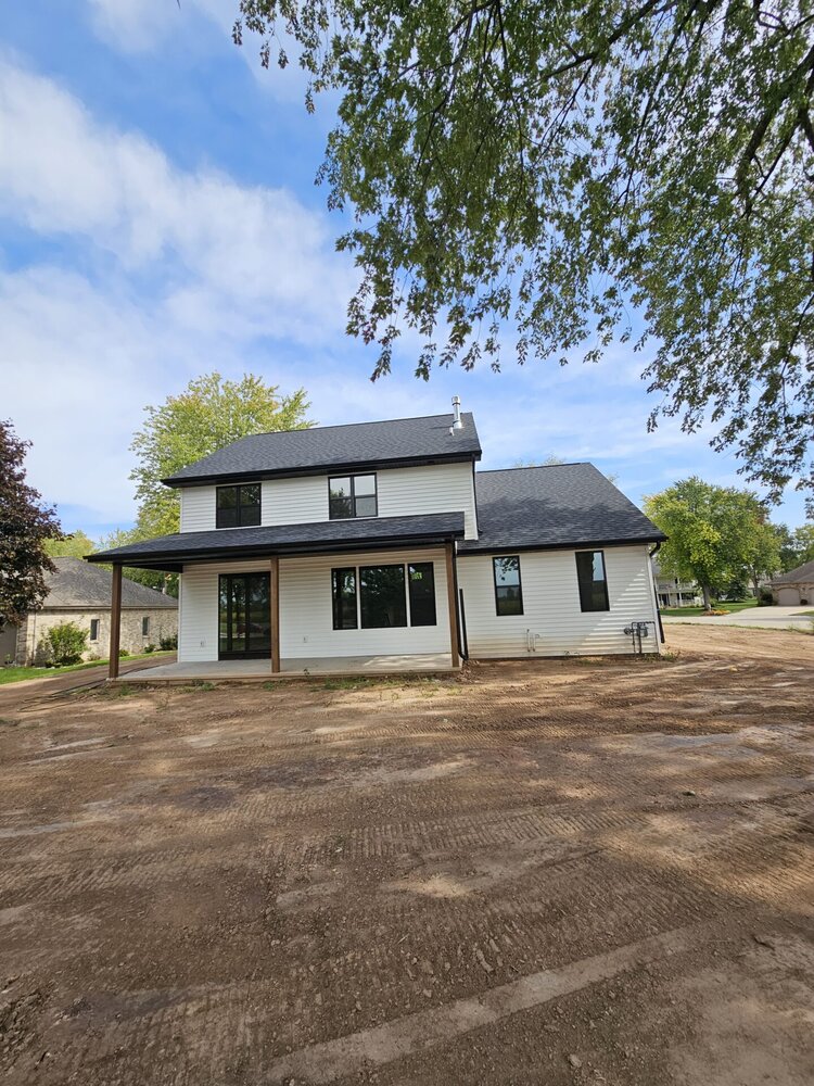 Rear view of modern custom home with covered patio built by Midwest Design Homes in Kaukauna