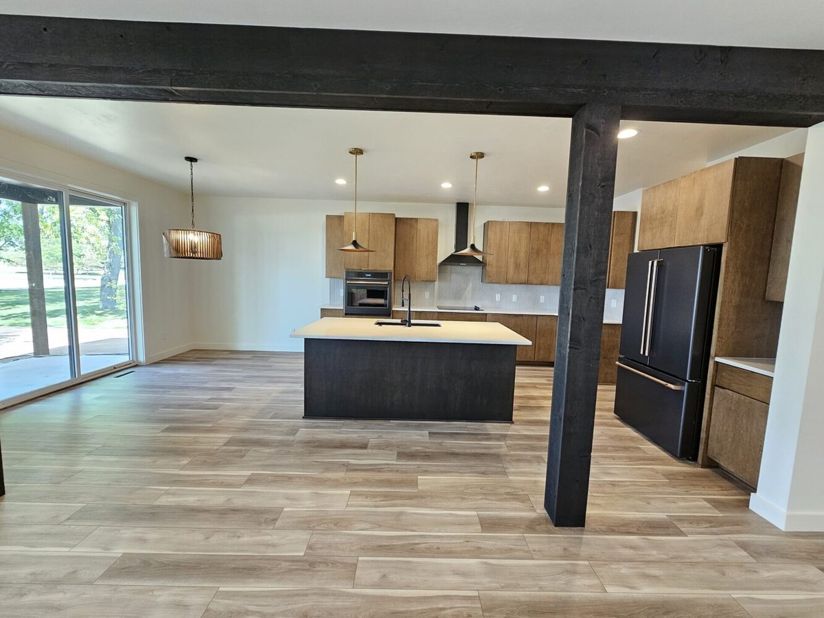 Spacious kitchen with island and wood cabinets in Kaukauna custom home by Midwest Design Homes
