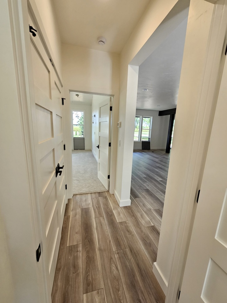 Transitional hallway with wood flooring in custom home by Midwest Design Homes in Kaukauna