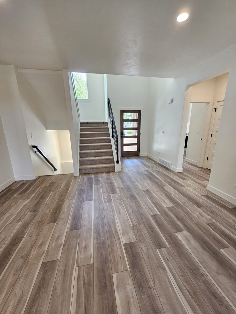View of entry and stairs from living area in Kaukauna home by Midwest Design Homes