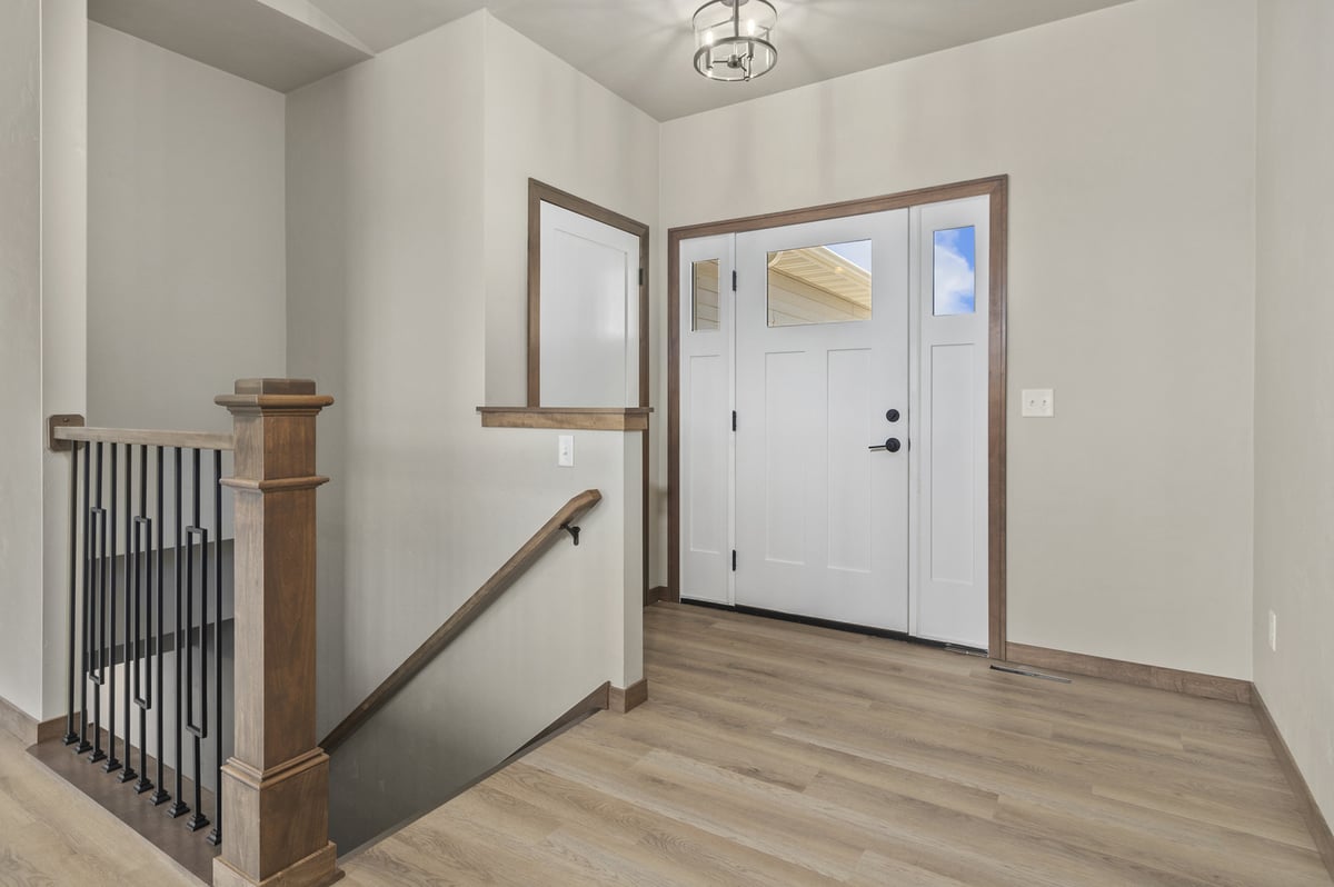 Bright front entry with staircase in Fox Cities area custom home by Midwest Design Homes